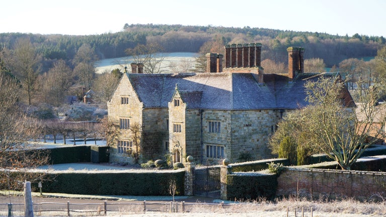 A frosty January morning at Bateman's. A view looking over a frosty field to the Bateman's house, set in the middle of the countryside.